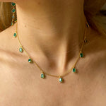 Model wearing the Tiggy Necklace in Gold and Green Onyx with matching earrings